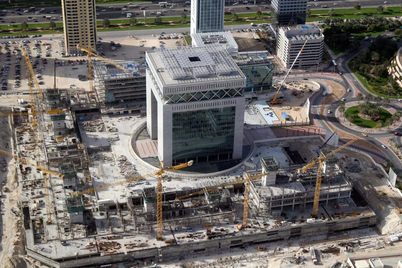 Aerial view of a large-scale commercial construction project with tower cranes