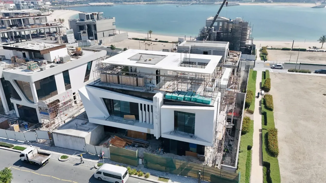 Waterfront residence under construction with site crew